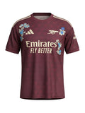 Archive Football Arsenal 2026/27 jersey in maroon with floral embroidery, team emblem, and breathable polyester fabric.
