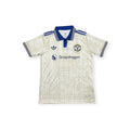 Archive Football Manchester United 2026/2027 special edition jersey in cream with blue collar and pinstripe details.