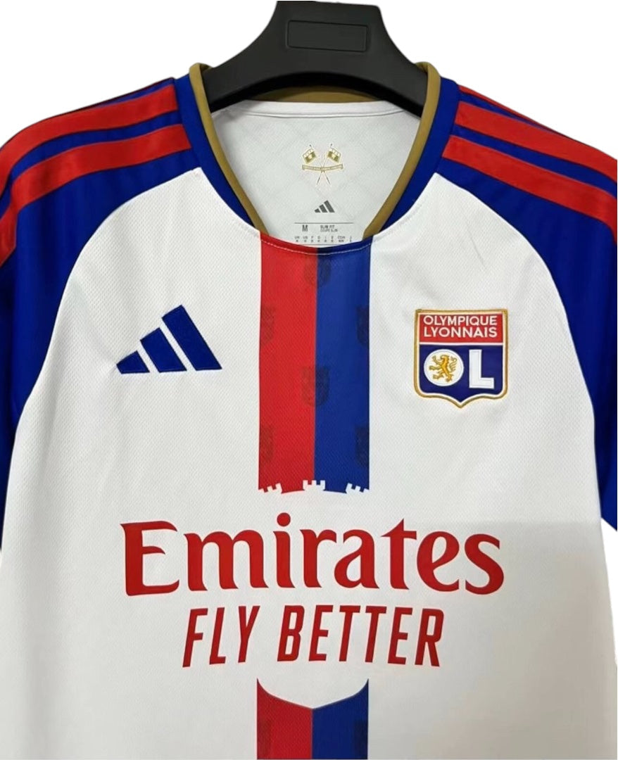 Archive Football Olympique Lyonnais 2026/27 home jersey in white with red and blue vertical stripe and team emblem.