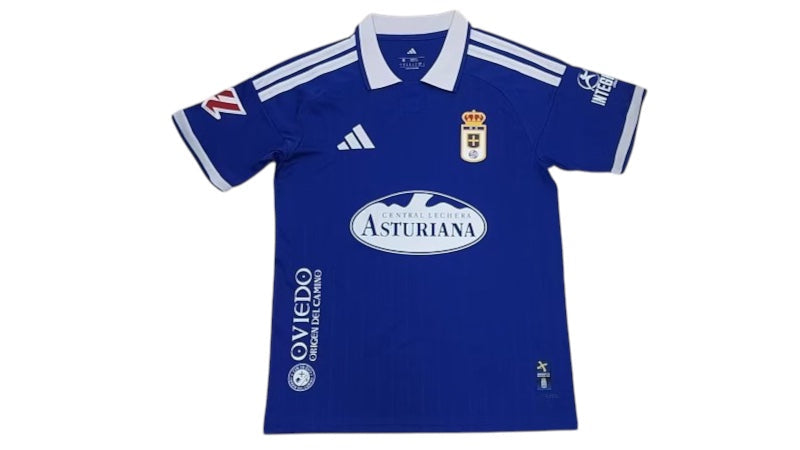 Archive Football Real Oviedo 2026/2027 home jersey in blue with white collar, team emblem, and sponsor logos.