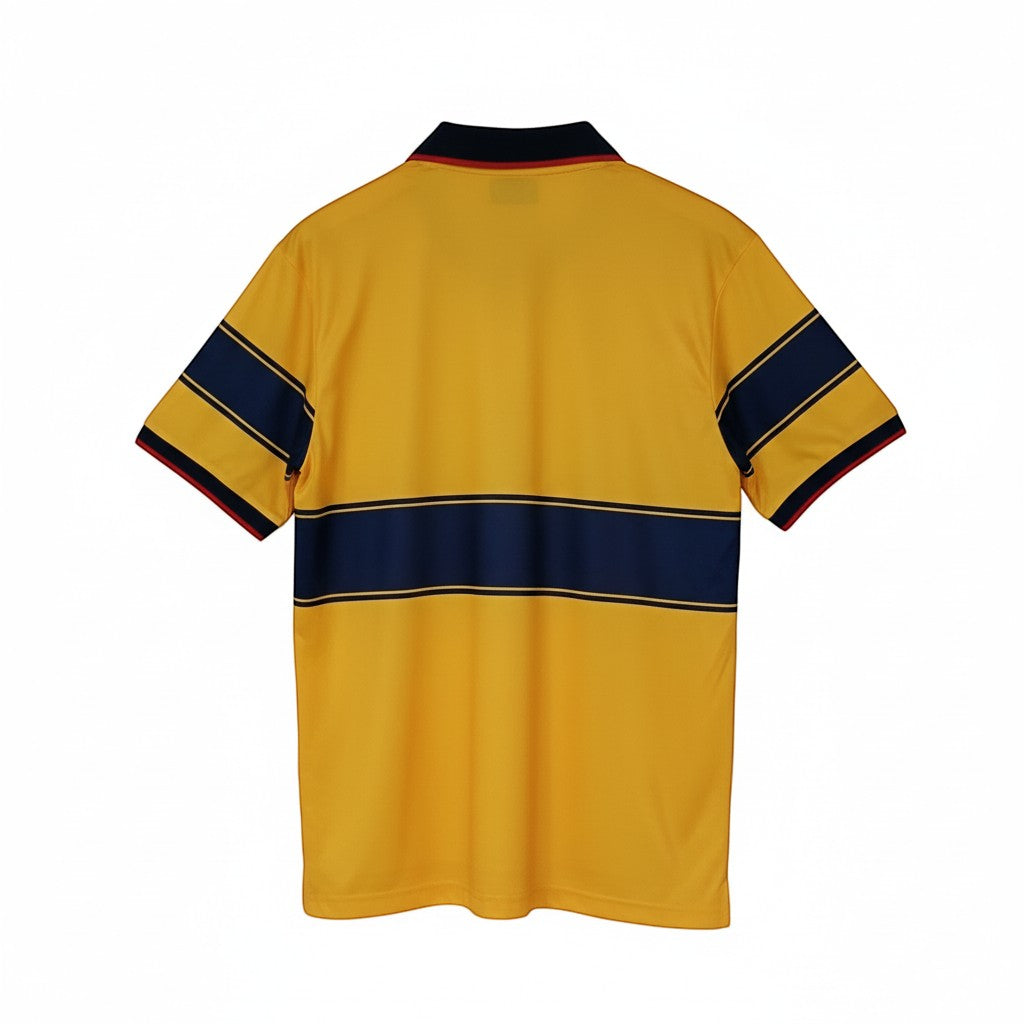 Hinchas Sportswear Store retro Arsenal away jersey 1997-99. Yellow with navy chest band, sleeve stripes, and red trim.