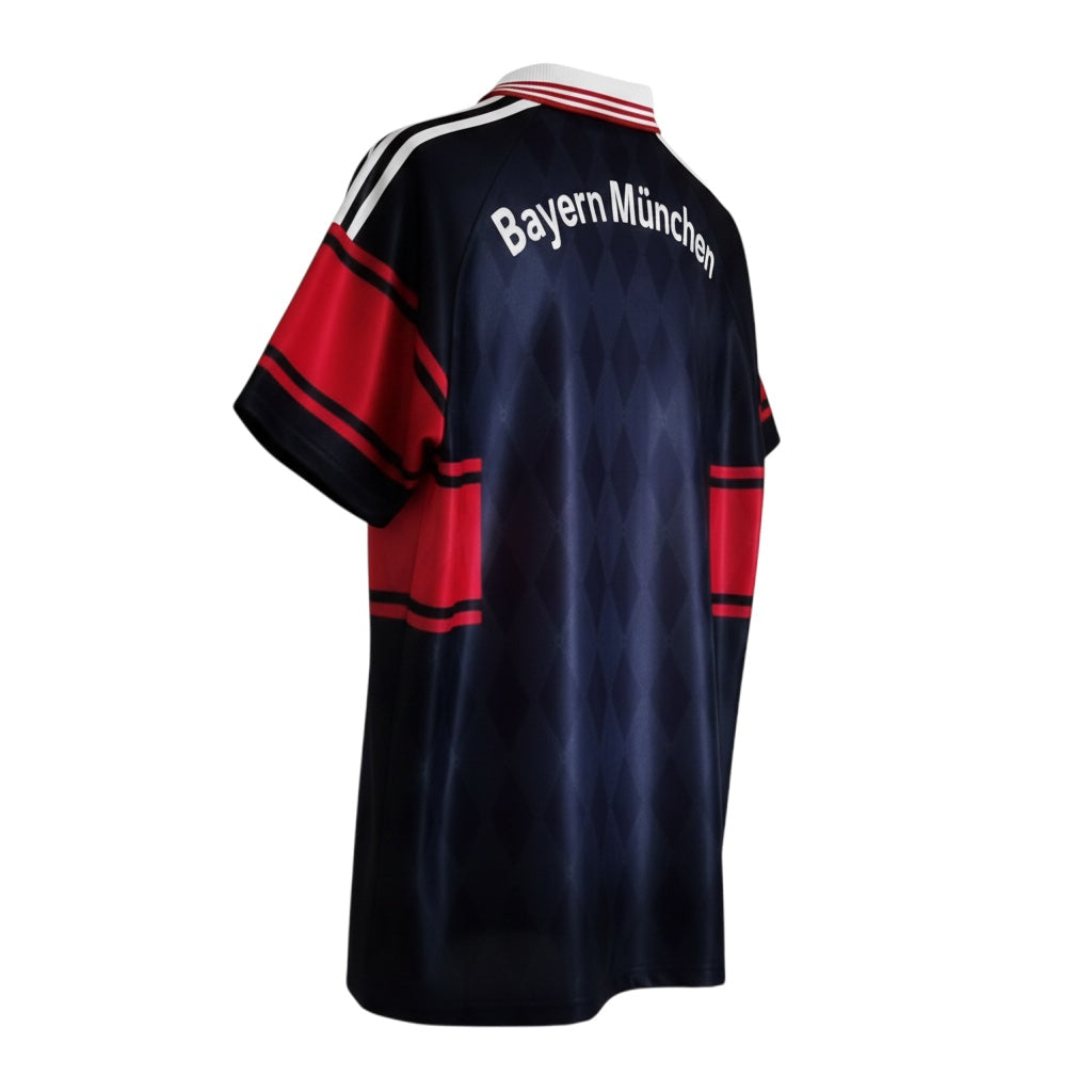 Hinchas Sportswear Store retro Bayern Munich 1997/98 home jersey. Navy-black with diamond jacquard, red sleeves and chest band, white collar.