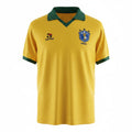 Hinchas Sportswear Store Brazil 1988 retro home jersey. Canary yellow satin-finish body with dark green polo collar and sleeve cuffs. Features Topper logo and vintage 3-star CBF crest.