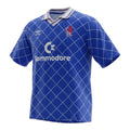 Hinchas Sportswear Store retro royal blue Chelsea 1987 home jersey with white diamond pattern, Commodore sponsor, and Umbro logo.