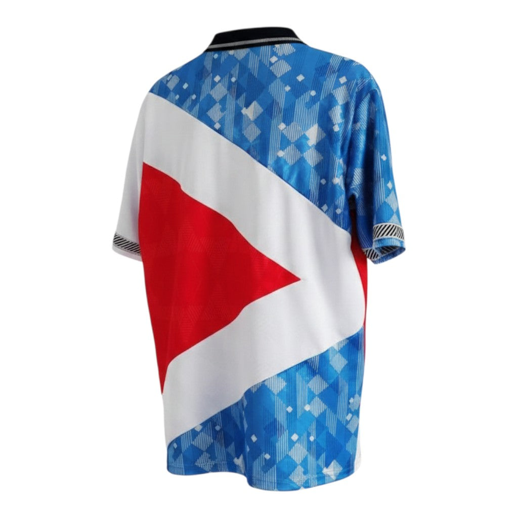 Hinchas Sportswear Store England Retro Third Jersey 1990, blue geometric pattern, red triangle, white panels, black and white striped cuffs and collar.