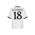 Hinchas Sportswear Store white retro Germany football jersey with Klinsmann 18 on the back and black, red, and yellow striped sleeves.