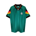 Hinchas Sportswear Store Germany retro 1992 away jersey in emerald green with black, red, and gold trim on collar and sleeves.