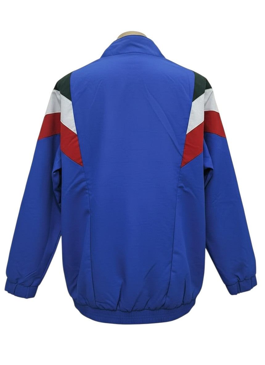 Hinchas Sportswear Store Italy Retro Windbreaker Jacket: royal blue with diagonal red, white, and green panels on chest and shoulders.