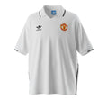 Hinchas Sportswear Store Manchester United 1980 retro away jersey, white with black Adidas stripes and V-neck collar.