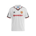 Hinchas Sportswear Store Manchester United 1984 retro away jersey, white with black and red trim V-neck, Sharp sponsor, Adidas logo.