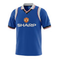 Hinchas Sportswear Store Manchester United 1984 retro royal blue Adidas jersey with white raglan sleeves and V-neck collar.