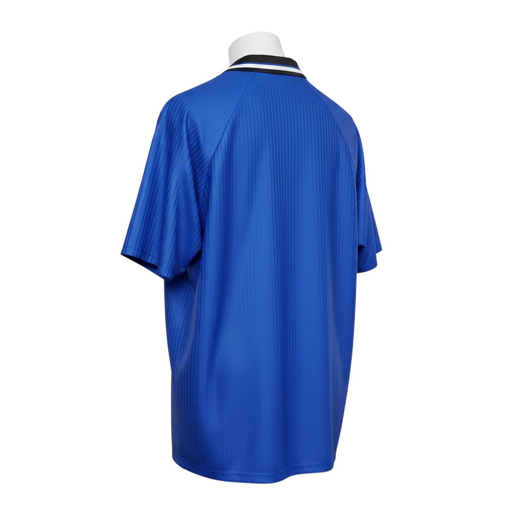 Hinchas Sportswear Store Manchester United 1996-97 retro third jersey, royal blue with black and white striped collar.