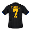 Hinchas Sportswear Store Manchester United 93-95 Cantona away jersey, black with yellow numbering and blue trim.