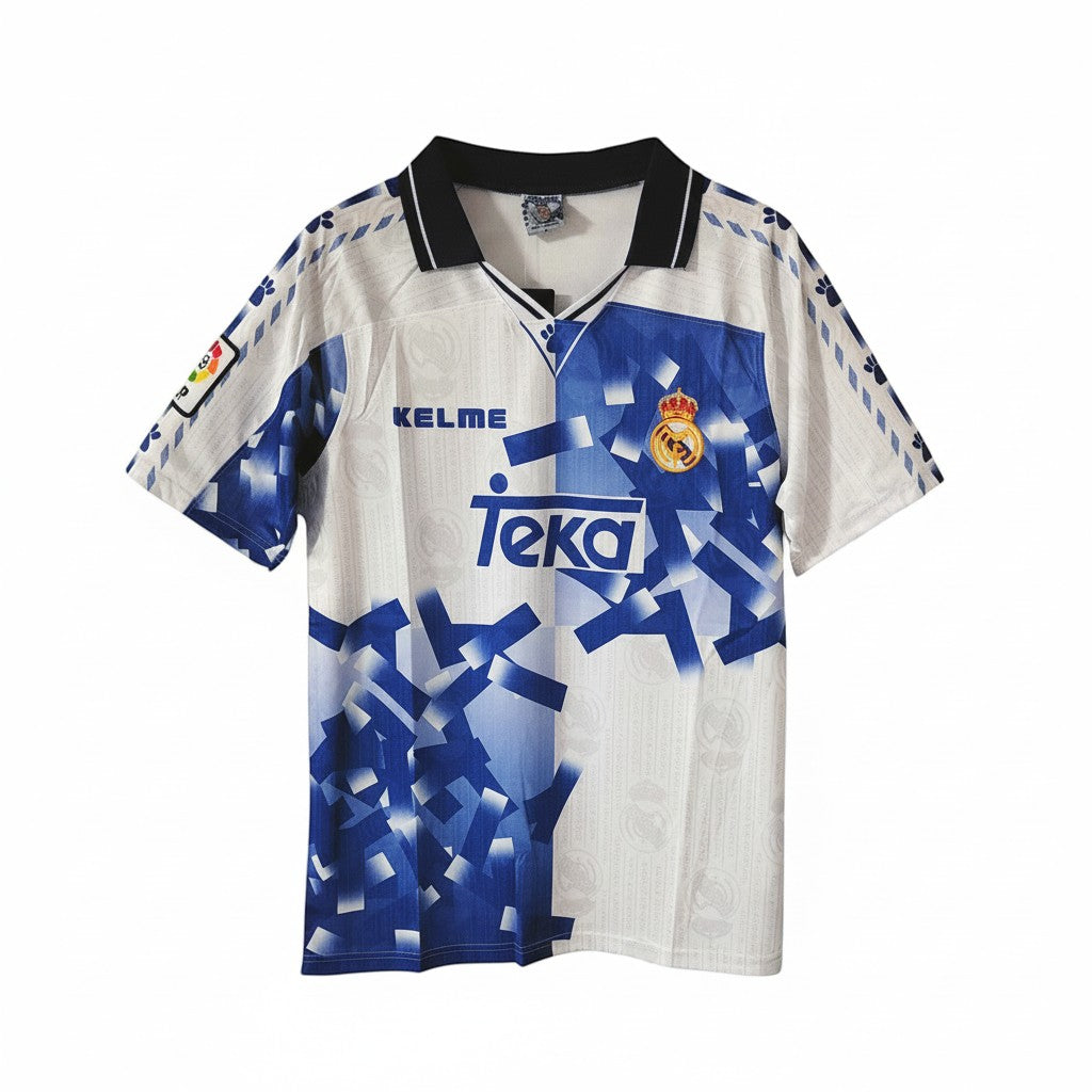 Hinchas Sportswear Store Real Madrid 1996-97 retro third jersey, white with blue geometric pattern, black collar, Kelme and Teka branding.