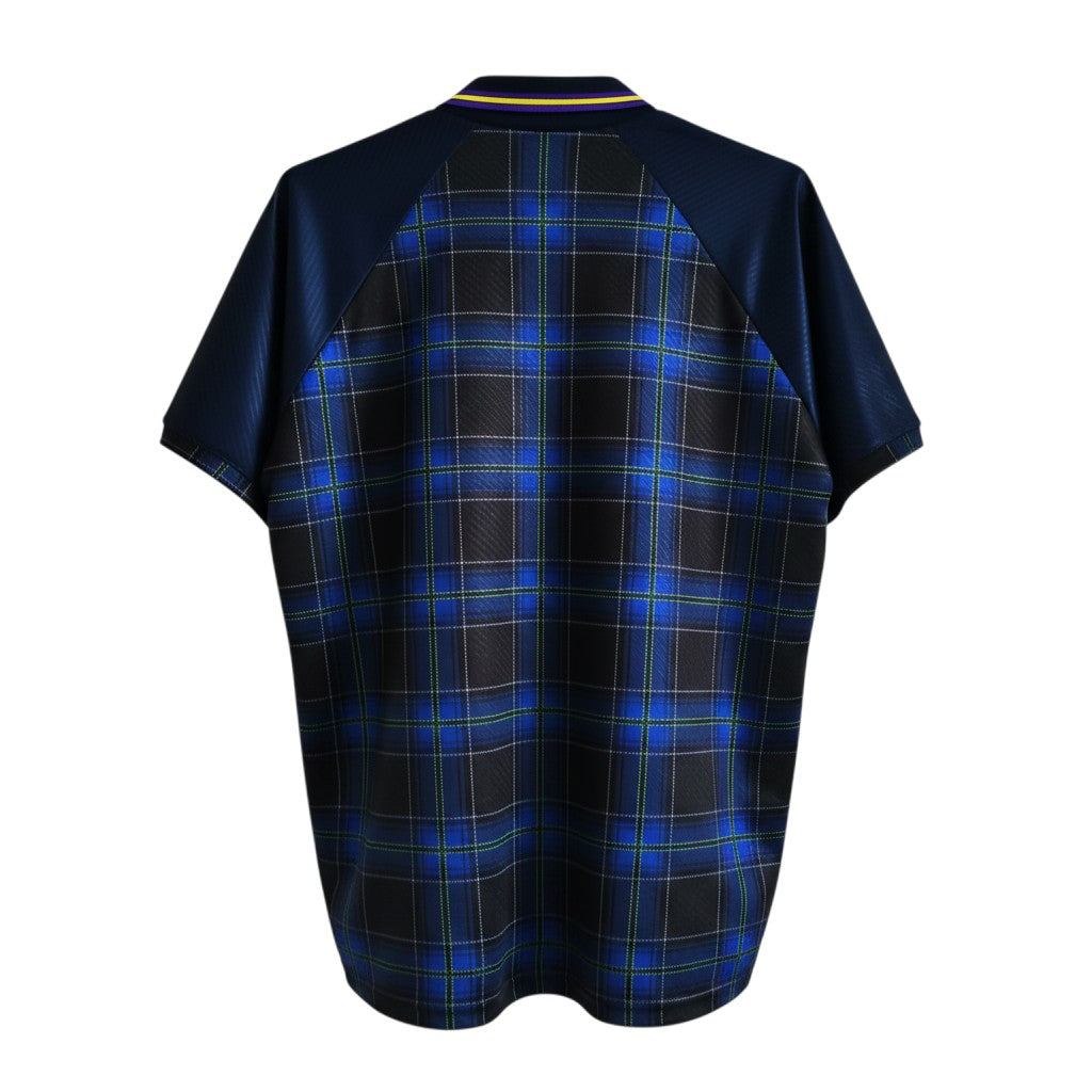 Hinchas Sportswear Store Scotland 1994 retro jersey with Black Watch tartan, navy sleeves, and purple/yellow collar.