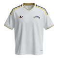 Hinchas Sportswear Store white Venezuela 2026 away jersey with gold trim and colorful stripes on shoulders.